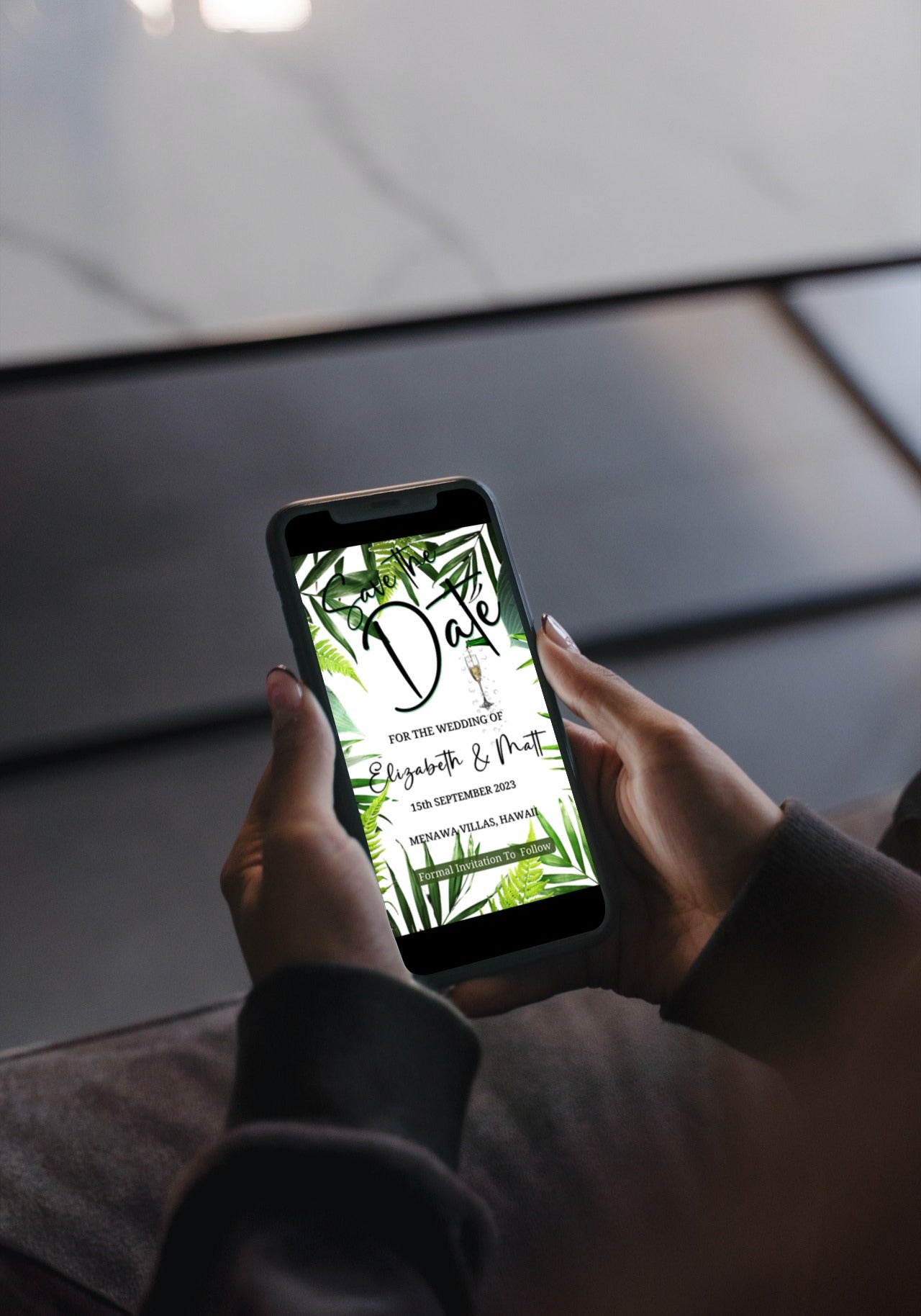 Person holding a phone displaying a customizable White Tropical Destination Save The Date Wedding Evite from URCordiallyInvited.