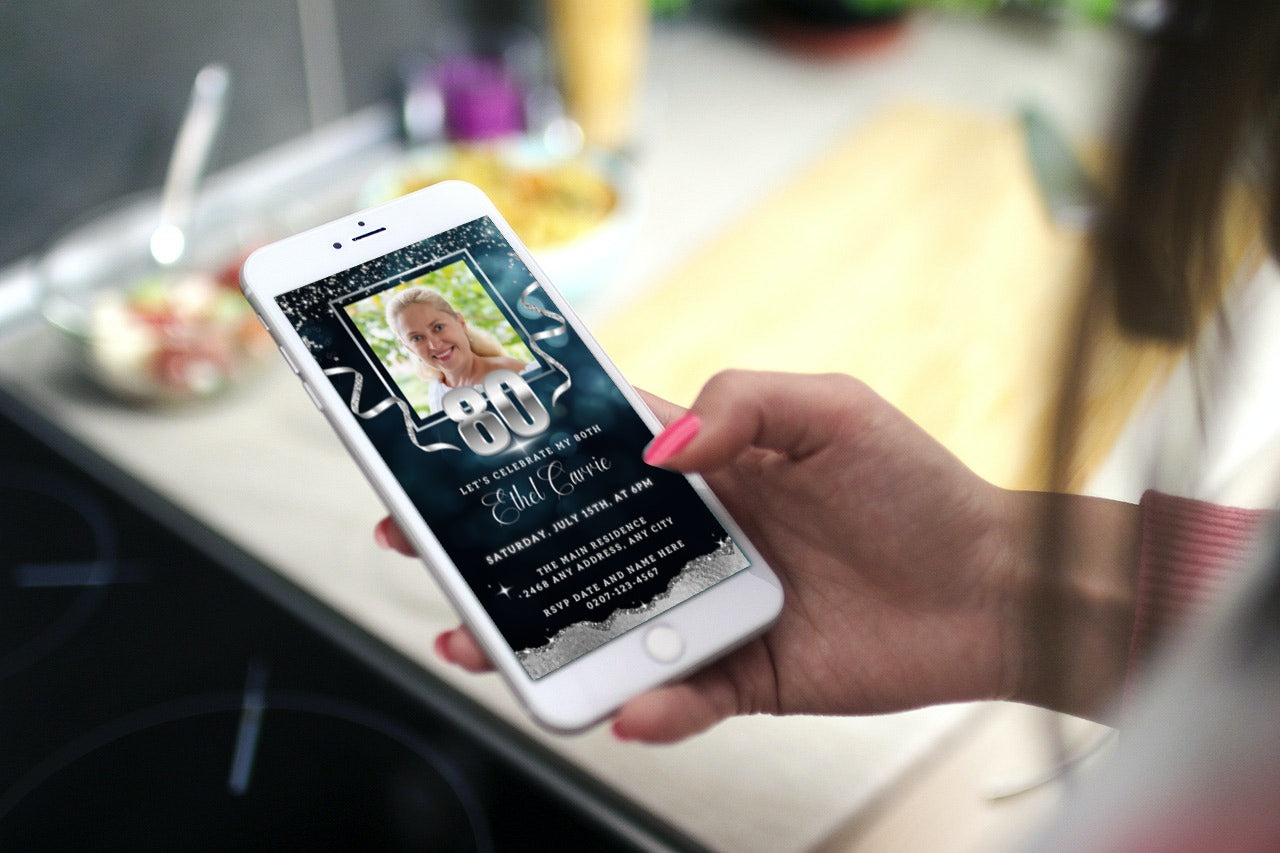 Hand holding a smartphone displaying the customizable Navy Blue Silver Glitter 80th Birthday Evite with a photo, ready for editing and electronic sharing.