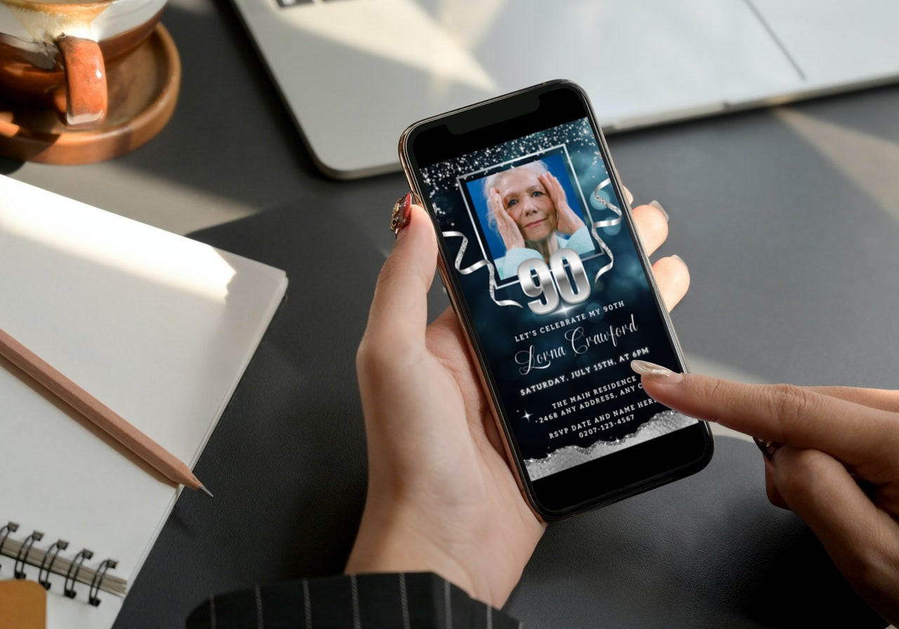 Person holding a smartphone displaying a customizable Navy Blue Silver Glitter 90th Birthday Evite with a photo of a woman.