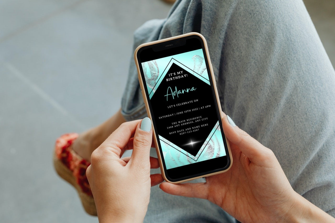 Person holding a smartphone displaying a Teal Black Silver Floral Customisable Birthday Evite from URCordiallyInvited.