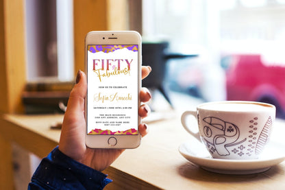 Hand holding a smartphone displaying a customizable digital invitation template for a Purple Pink White | Fifty & Fabulous Party Evite.