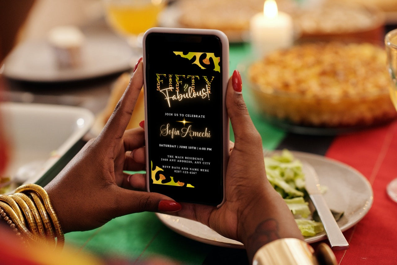 Person holding a smartphone displaying a customizable digital invitation template for a Fifty & Fabulous party with green, gold, and black animal print design.