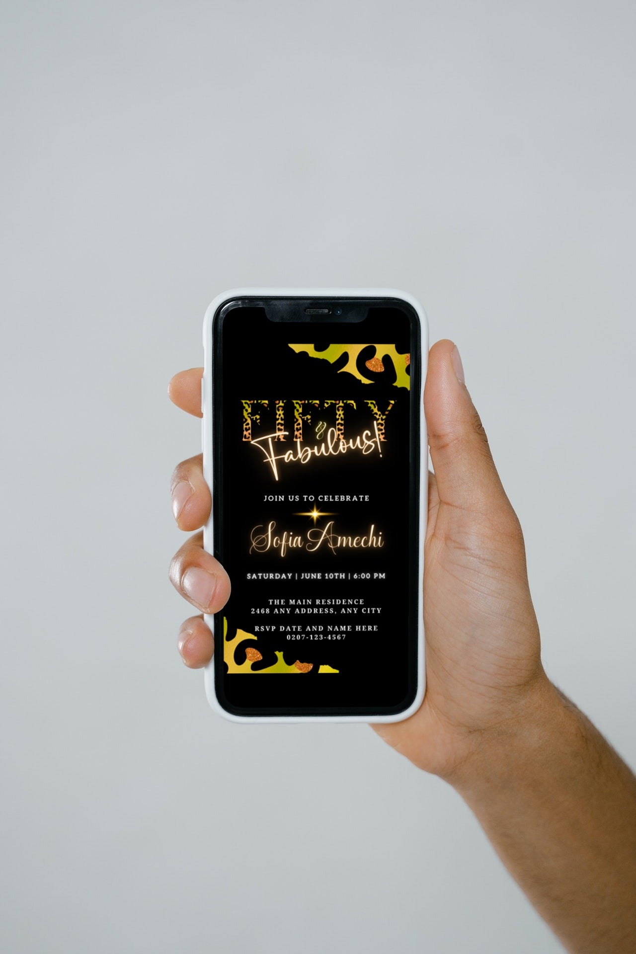 Hand holding a smartphone displaying a customizable digital invitation template titled Green Gold Neon Black Animal Print | Fifty & Fabulous Party Evite.