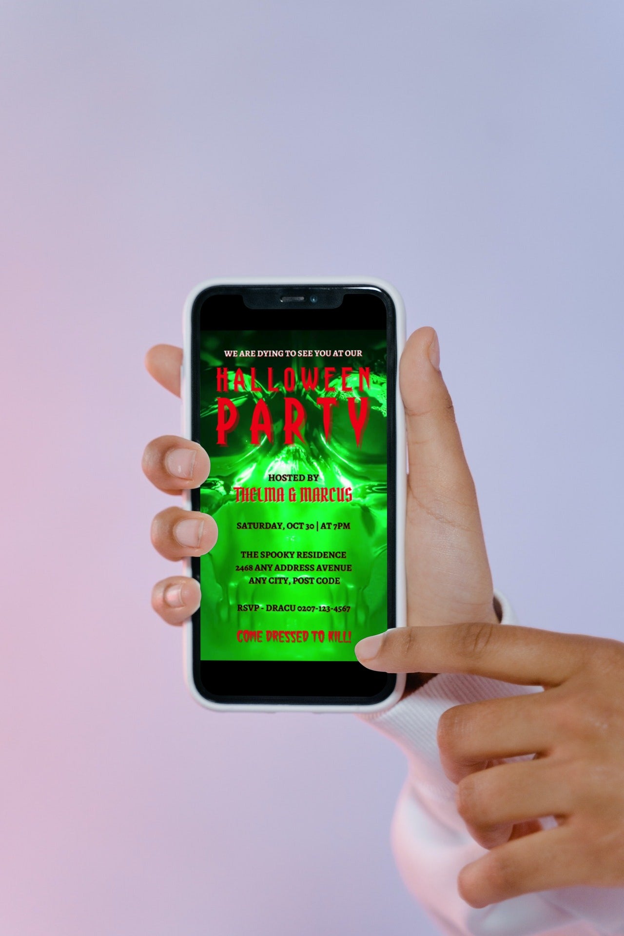 Hand holding a phone displaying the Neon Green Skull Halloween Party Video Invite, a customizable digital invitation template from URCordiallyInvited.