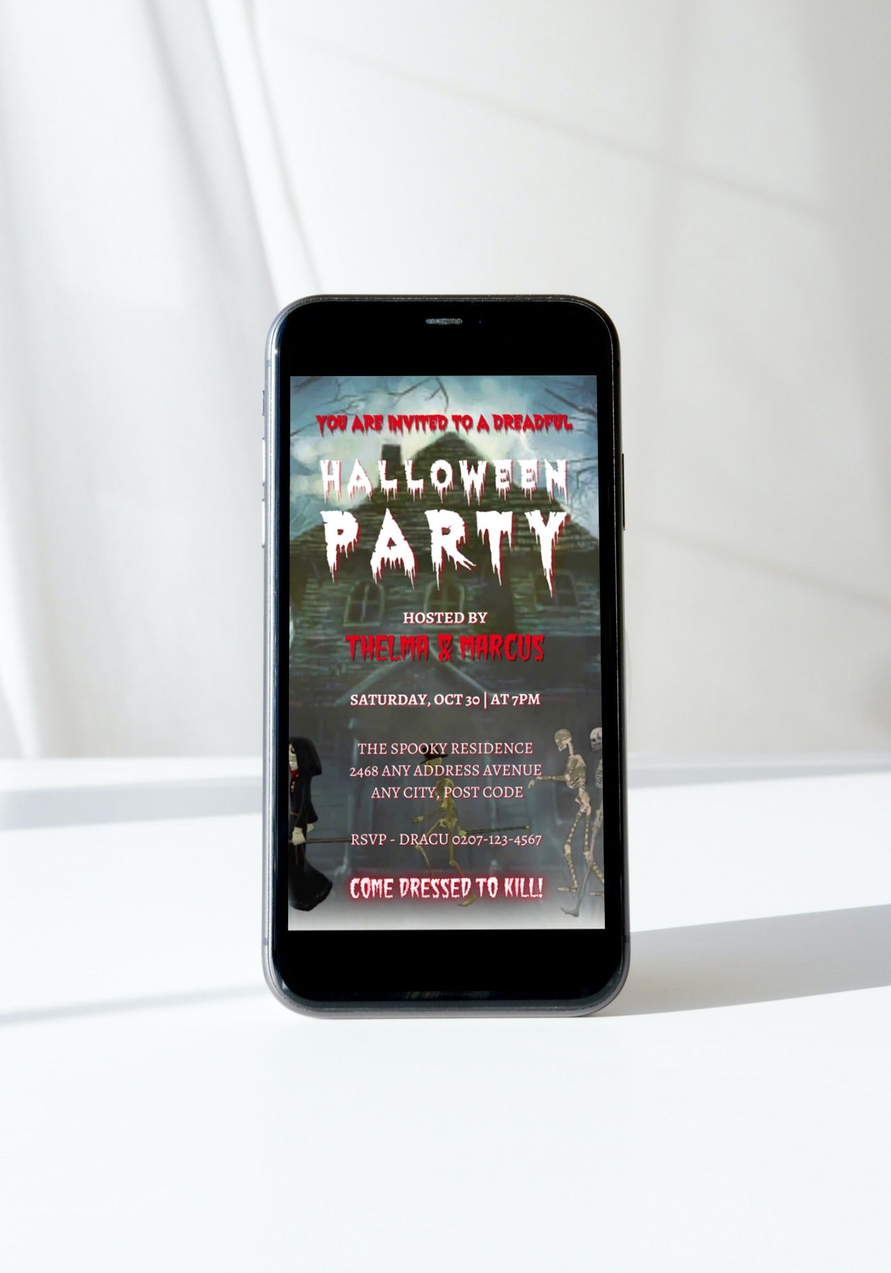 Cell phone displaying a digital Halloween party video invitation with a skeleton and spooky text from URCordiallyInvited.