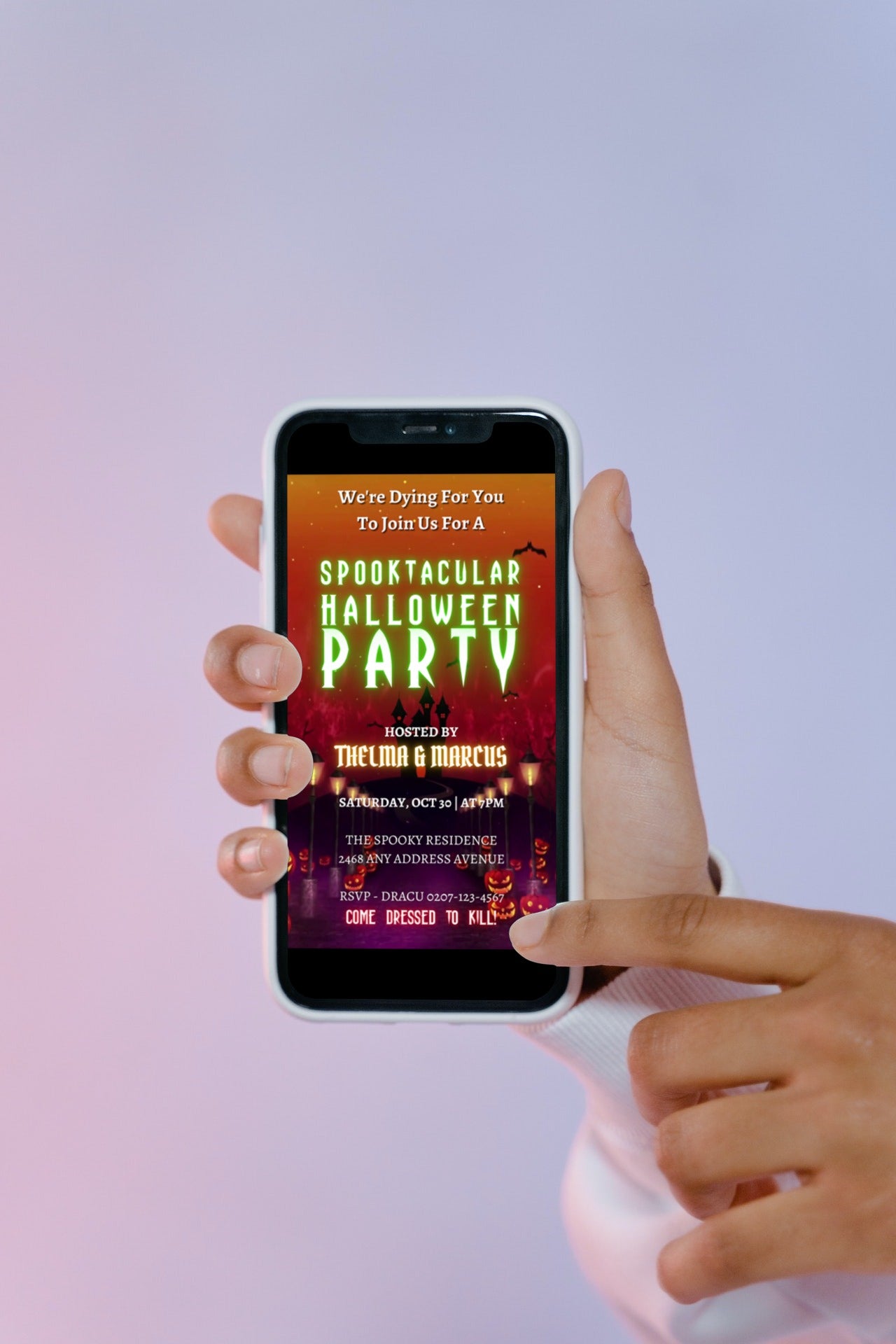 A hand holding a phone displaying the 'Haunted House Road | Halloween Party Video Invite' template, showcasing a spooky digital invitation.
