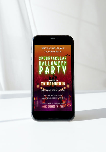 Cell phone displaying a digital, editable Halloween Party Video Invite titled Haunted House Road, featuring spooky imagery and customizable text through Canva.
