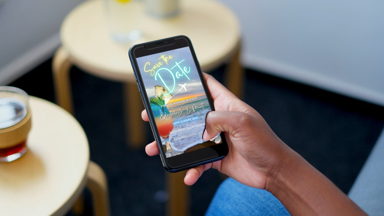 A person holding a smartphone displaying a customizable Sunset Beach Cocktail Destination Save The Date Video Invitation template for editing and sharing.