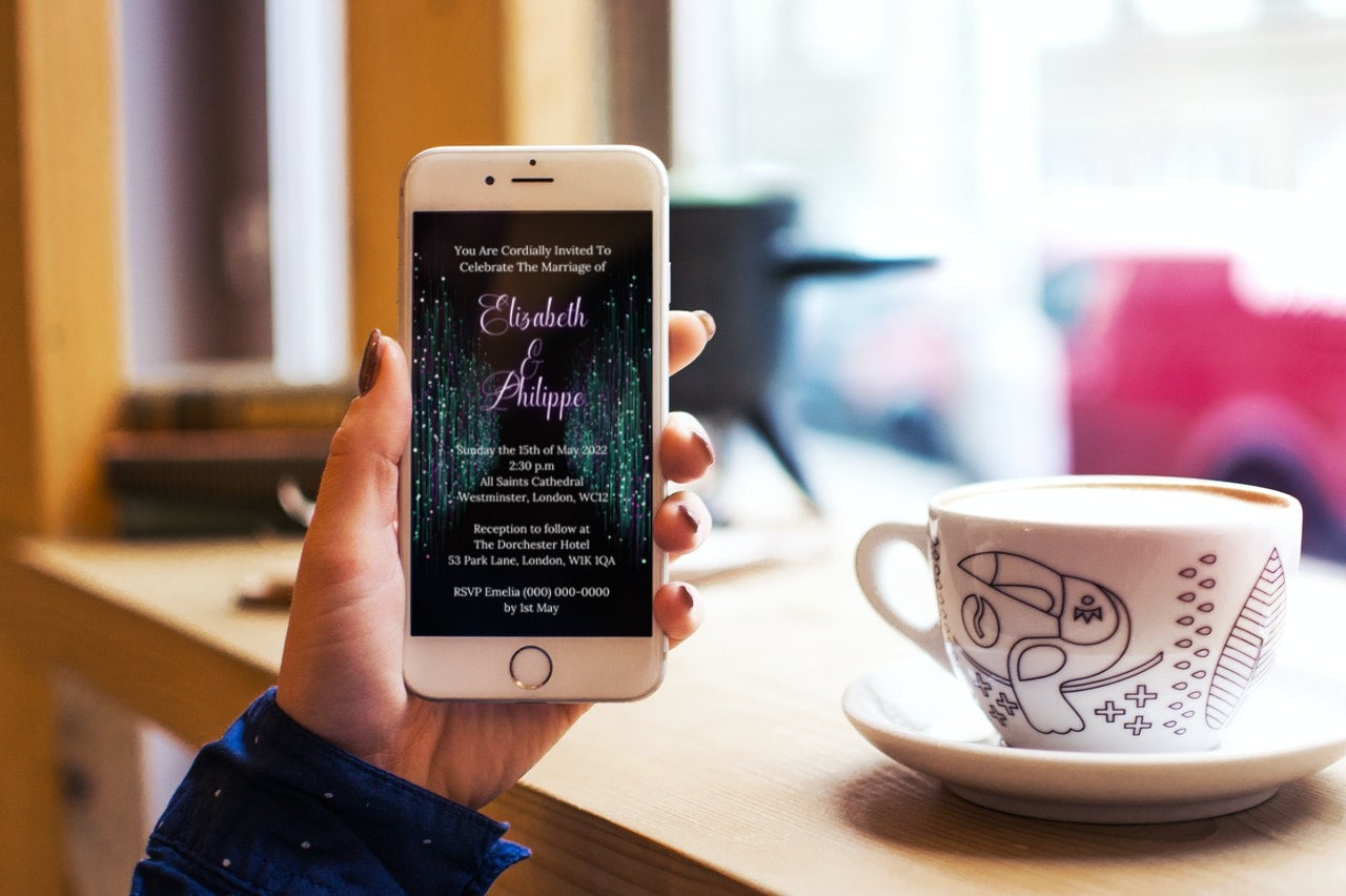 Hand holding a phone displaying a Green Purple Glitter Wedding Video Invitation template, ready for customization in Canva for digital sharing.