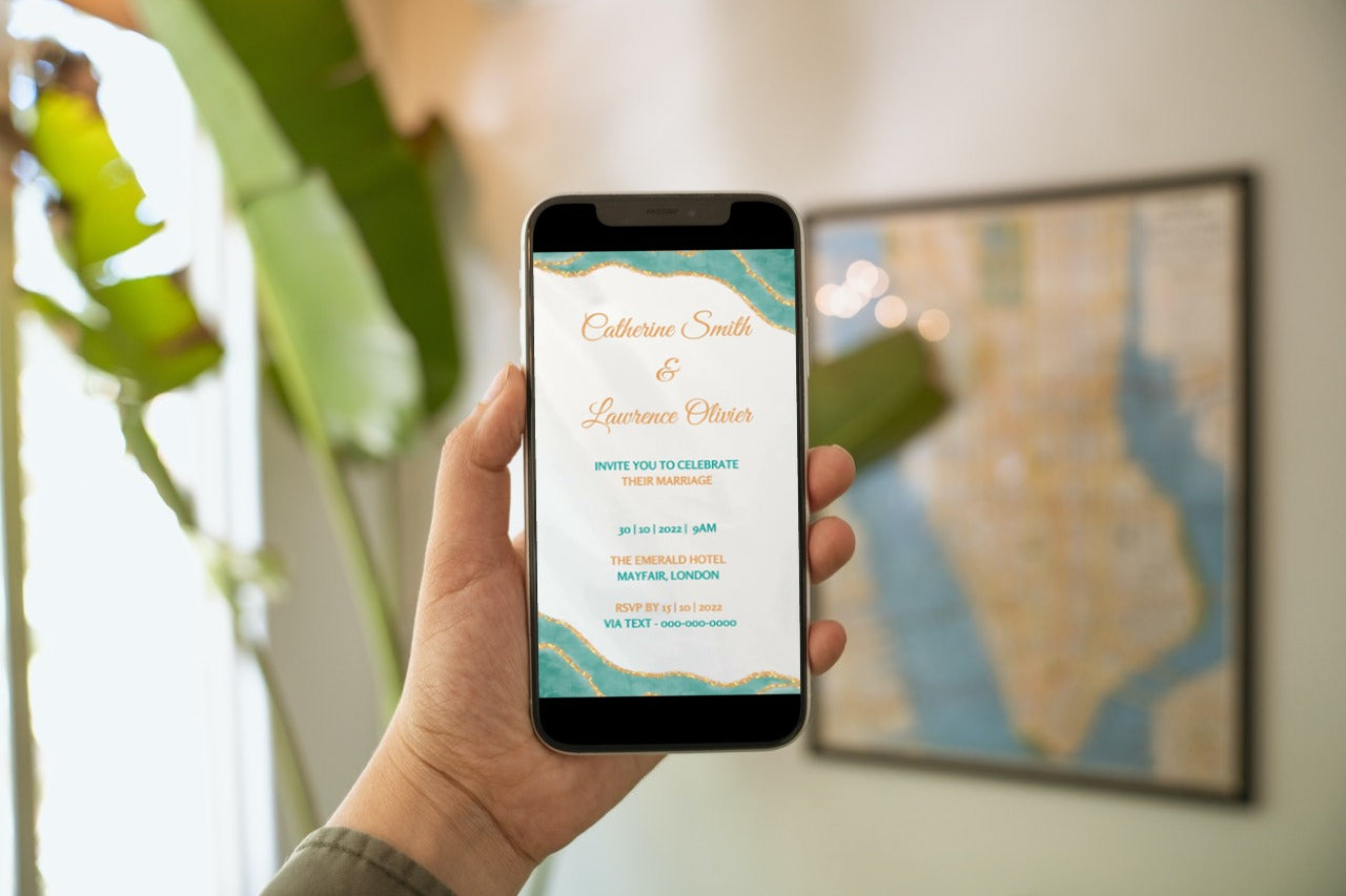 Hand holding a smartphone displaying a customizable Teal Blue Agate Wedding Video Invitation from URCordiallyInvited, editable via Canva for easy digital sharing.