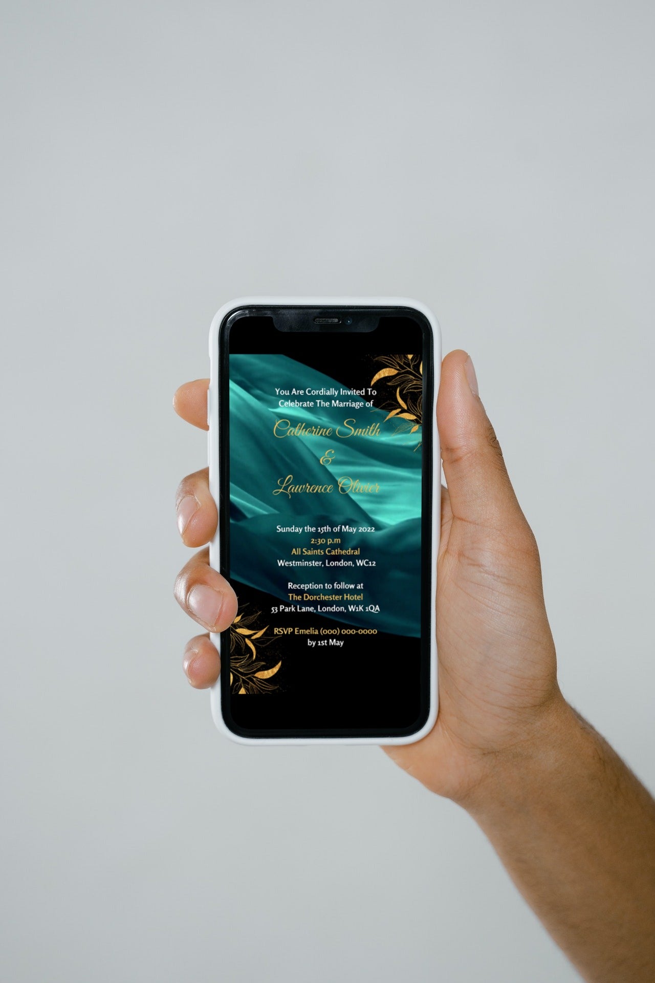 Hand holding a smartphone displaying a customizable Green Silk Chiffon Wedding Video Invitation template from URCordiallyInvited.