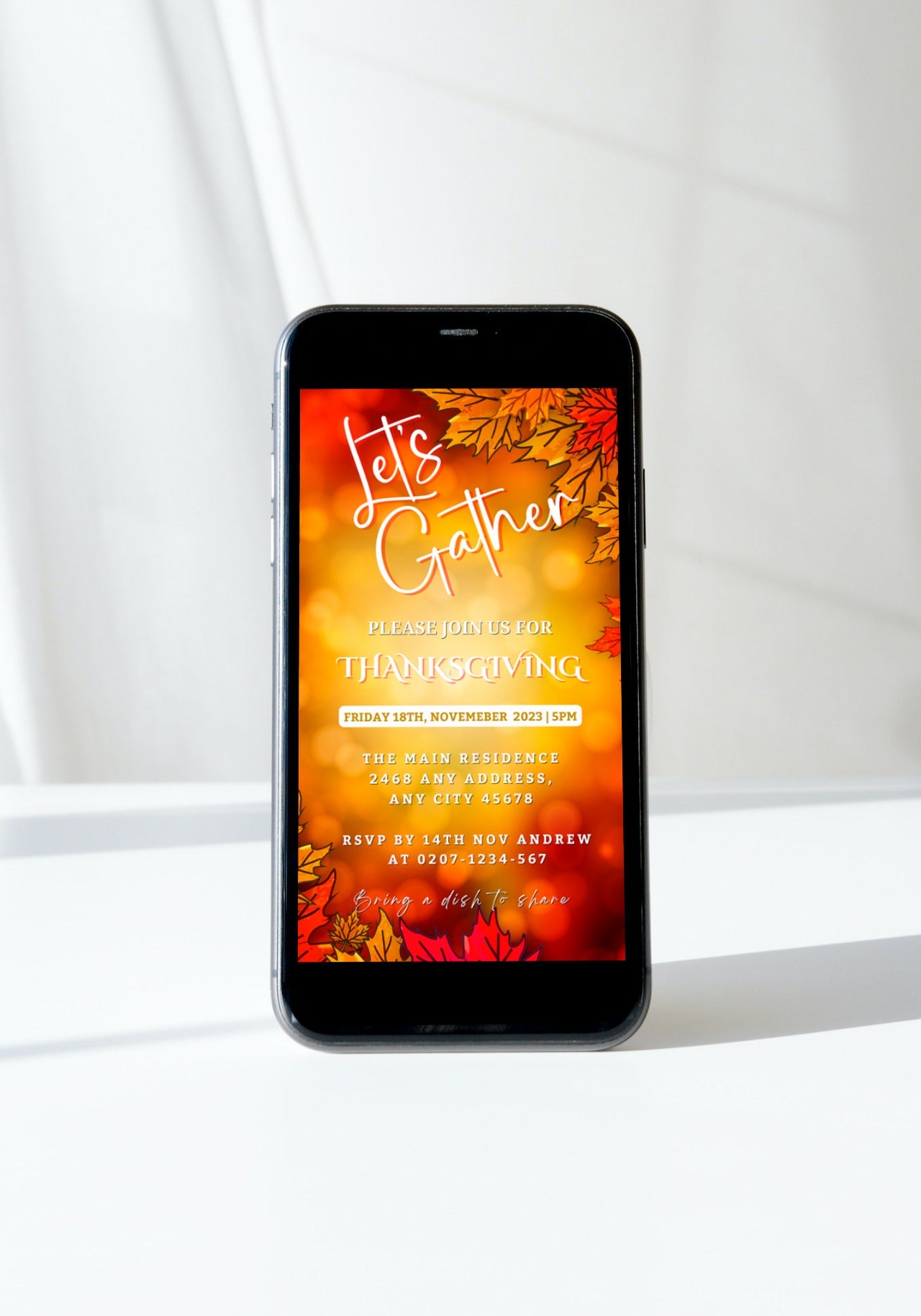 Smartphone displaying Let's Gather Orange Leaves Bokeh Thanksgiving Dinner Evite template, showcasing a customizable digital invitation for electronic sharing via text, email, or messaging apps.