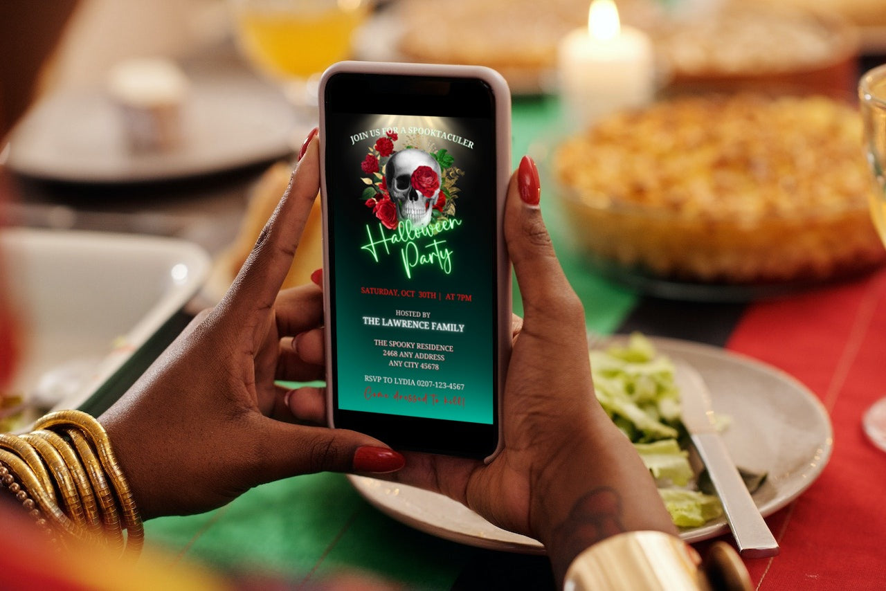 Person holding a phone displaying a customizable Red Rose Illuminated Skull | Halloween Evite template from URCordiallyInvited, ready for editing in Canva.
