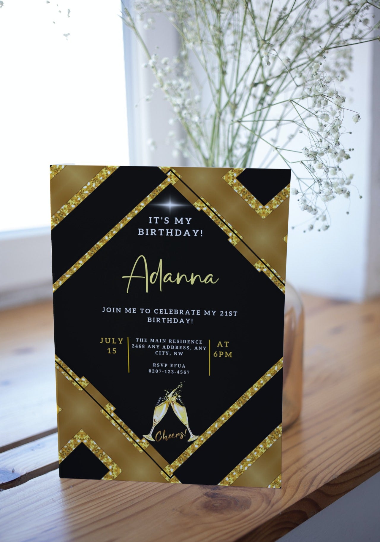 Gold Black Glitter Champagne Editable Party Evite next to a vase of white flowers, customizable for events via Canva on PC, tablet, or mobile.