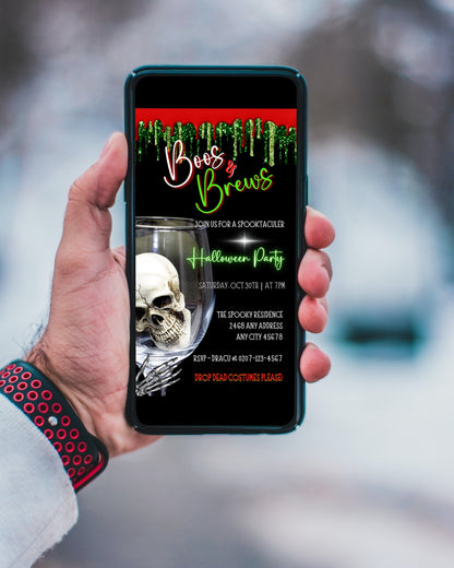 Hand holding a mobile phone displaying the Boos & Brews Glass Skull | Halloween Evite template, featuring a skull in a wine glass.