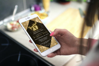 Hand holding a phone displaying the Thankful AF Golden Leaves Diamond Thanksgiving Dinner Evite template, customizable via Canva for easy digital invitations.