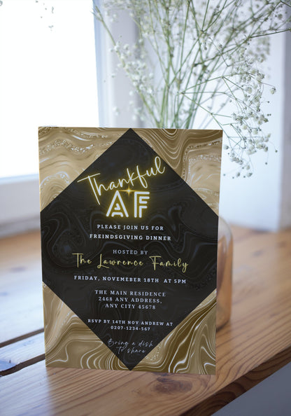 Gold Pumpkin Glitter Foil | Thankful AF Thanksgiving Evite template displayed with white flowers in front. Customizable digital invitation for Thanksgiving, editable via Canva.