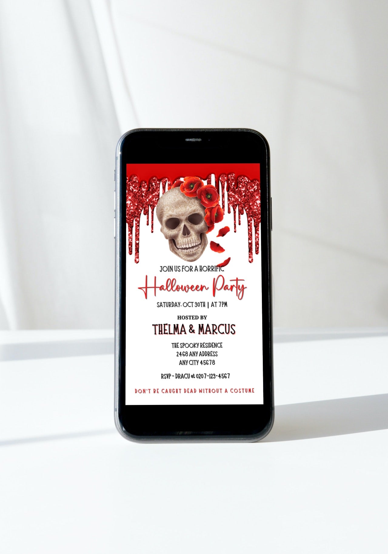 Cell phone displaying Dripping Red Fancy Rosey Skull Halloween Evite template with customizable text and skull with red flowers.