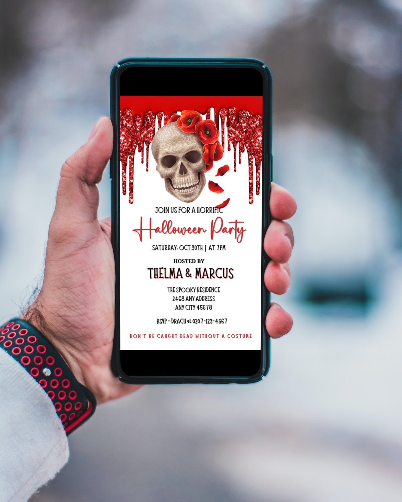 Hand holding a cell phone displaying the Dripping Red Fancy Rosey Skull Halloween Evite with skull and red flowers design.