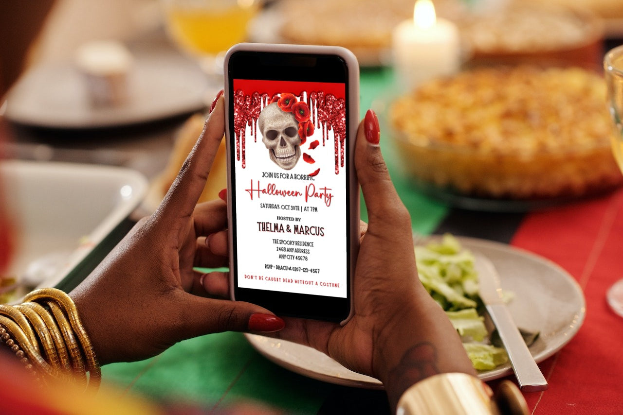 Person holding a phone displaying the Dripping Red Fancy Rosey Skull Halloween Evite, a customizable digital invitation template from URCordiallyInvited.