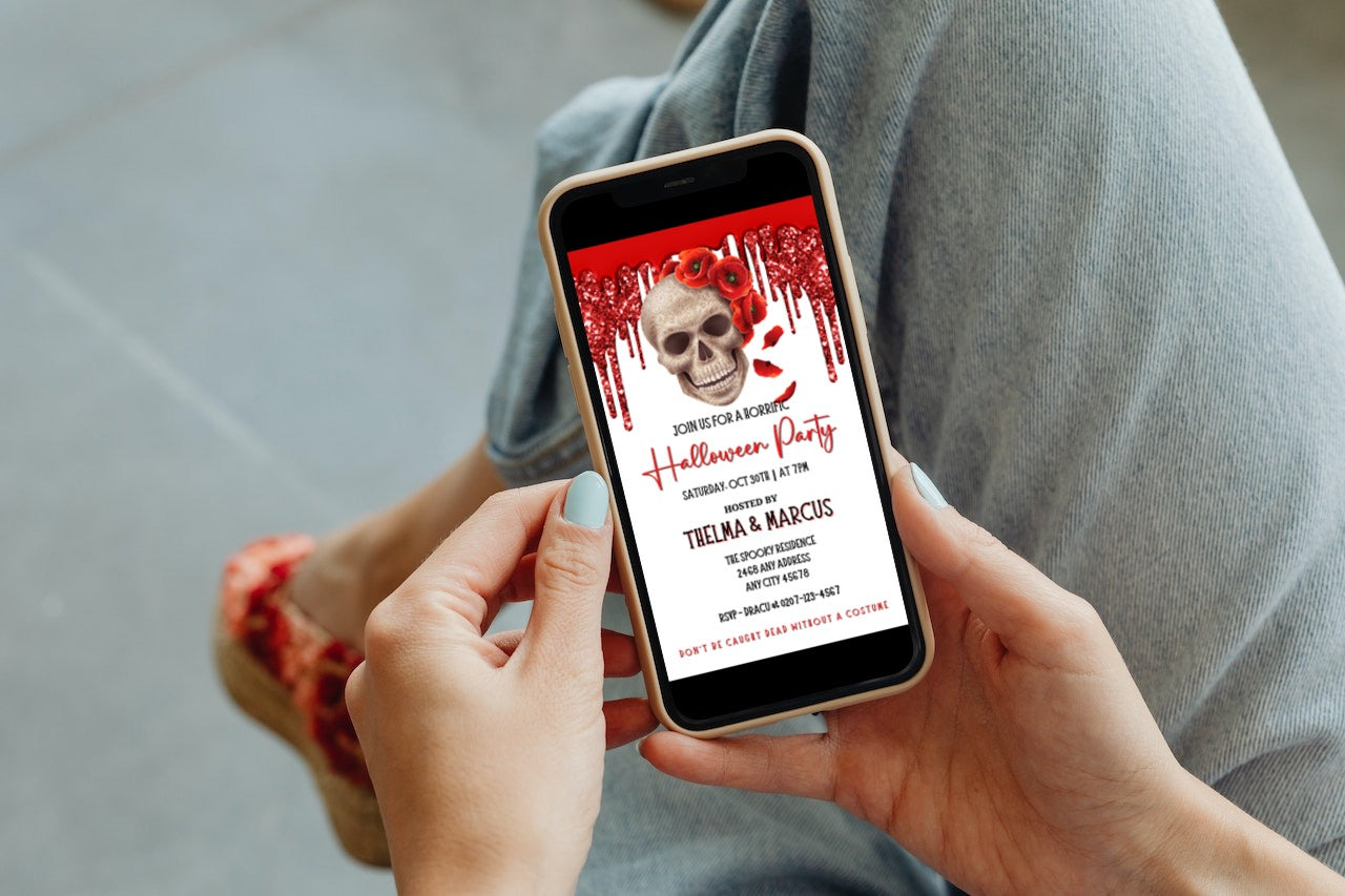 Person holding phone displaying Dripping Red Fancy Rosey Skull Halloween Evite template, customizable via Canva for digital invitations.