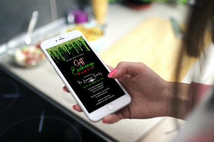 Hand holding a phone displaying the Green Drip Gift Exchange Party Invitation template for easy customization via Canva.