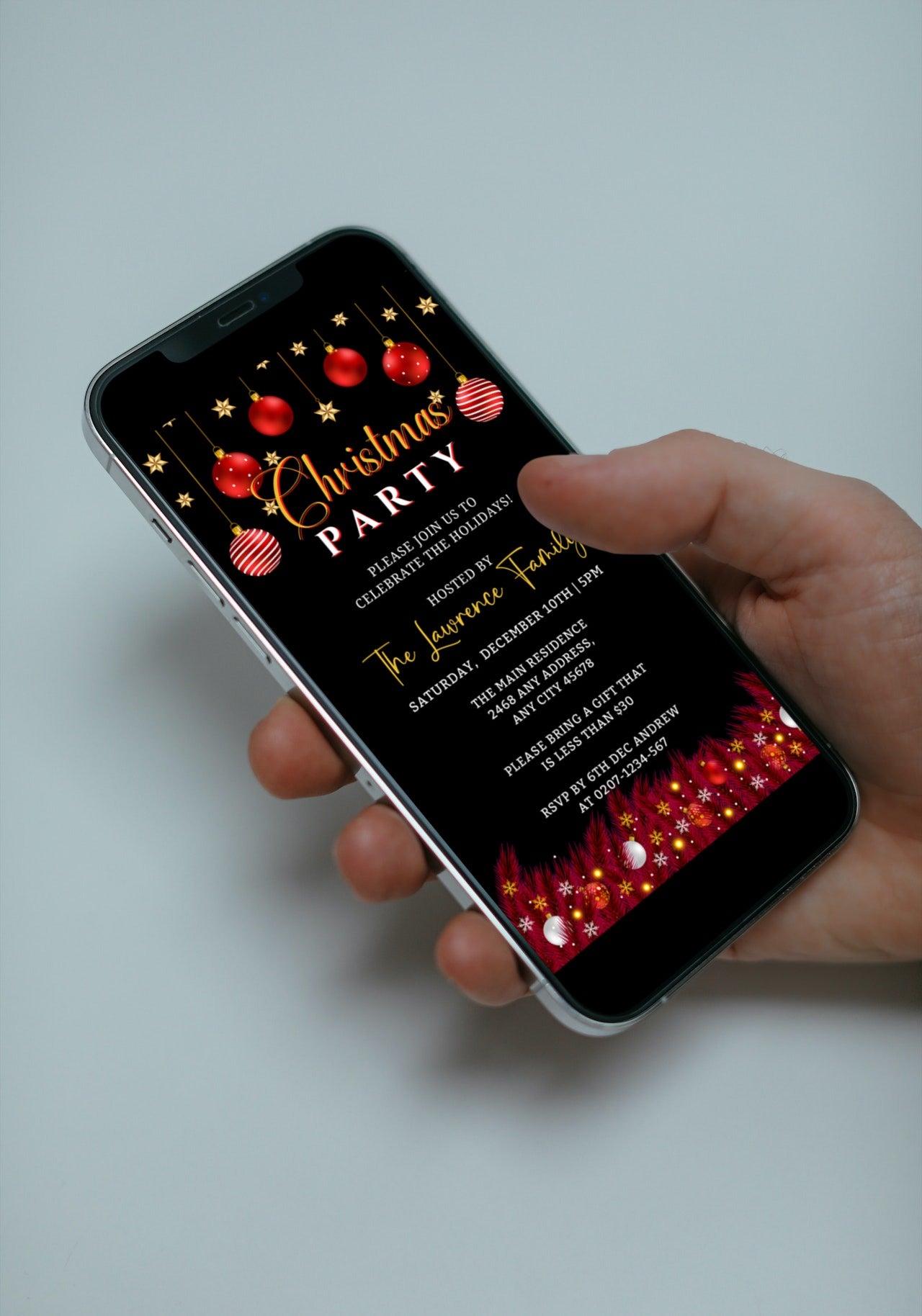 Hand holding a smartphone displaying an editable digital Red Black Gold Ornament Christmas Party Evite template from URCordiallyInvited.