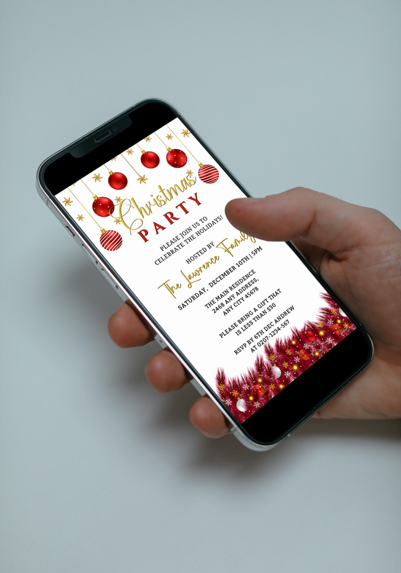 Hand holding a smartphone displaying a customizable White Red Gold Ornament Christmas Party Evite template.