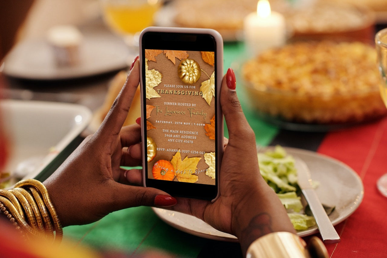 Person holding a phone displaying a Thanksgiving invitation featuring Beige Gold Leaves Pumpkin design from URCordiallyInvited.