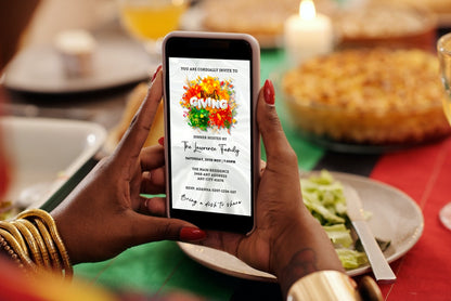 Person holding a phone displaying a Thanksgiving Dinner Evite with a customizable template for digital invitations via Canva.