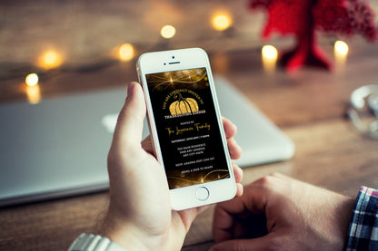 Person holding a phone displaying the Golden Pumpkin Sparkle Thanksgiving Dinner Evite template, customizable via Canva for digital sharing.