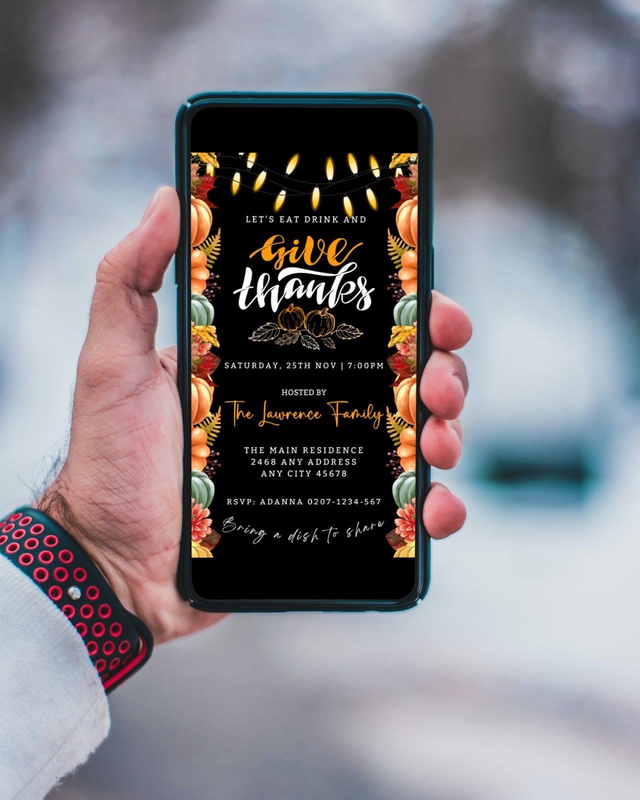 Hand holding a mobile phone displaying the Colourful Lit Leaves Pumpkins Black | Thanksgiving Evite customizable digital invitation template from URCordiallyInvited.
