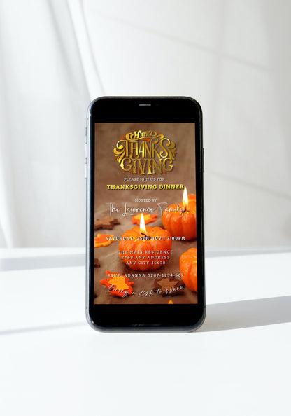 A smartphone displaying a Gold Lit Pumpkins | Thanksgiving Evite template with a candle in a pumpkin beside it.