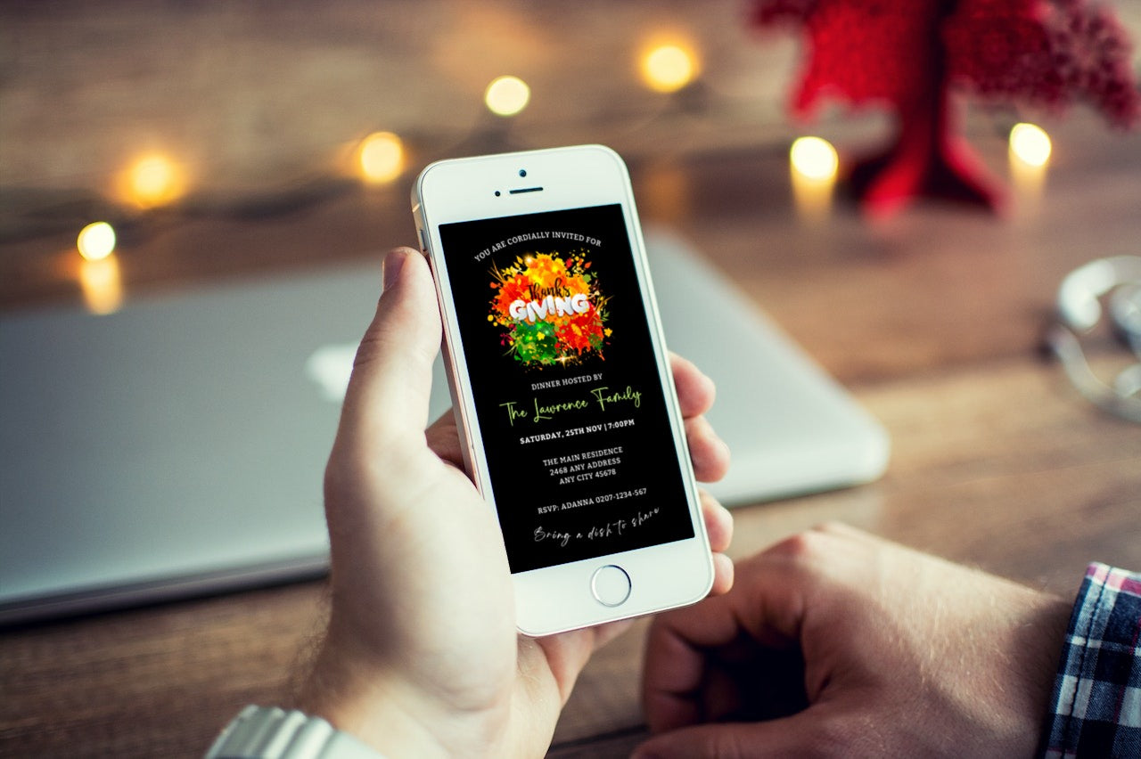 Person holding a smartphone displaying the Colourful Neon Floral Black | Thanksgiving Dinner Evite template from URCordiallyInvited.