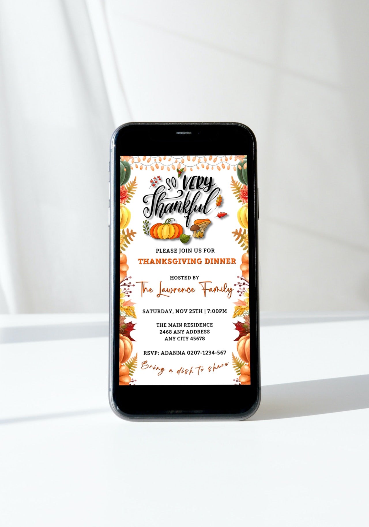 Cell phone displaying a Colourful Fall Leaves Pumpkins Thanksgiving Evite template for customization via Canva.
