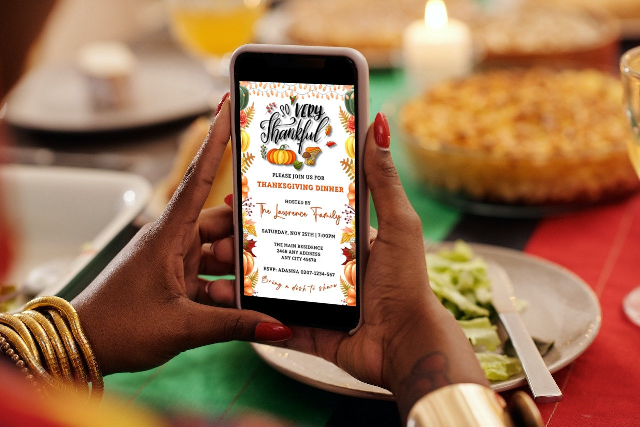 Person holding a phone displaying the Colourful Fall Leaves Pumpkins | Thanksgiving Evite invitation template, ready to be personalized and shared digitally.