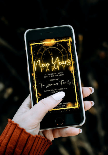 Hand holding a smartphone displaying an editable Roman Clock Golden Frame New Years Party Evite template for personalizing with Canva.