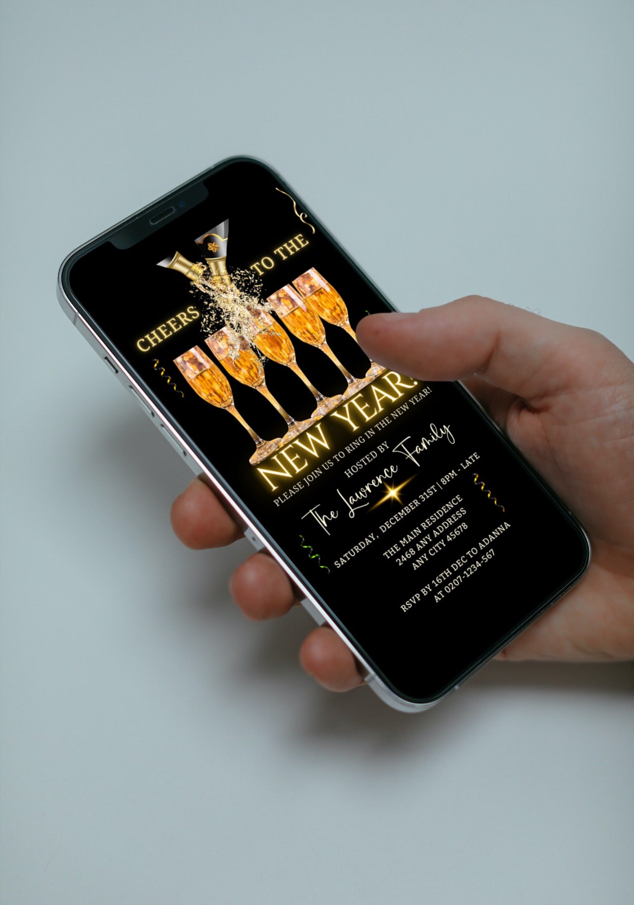 Hand holding a smartphone displaying the Splashing Champagne Neon Cheers NY | New Years Party Evite template for digital invitation customization.