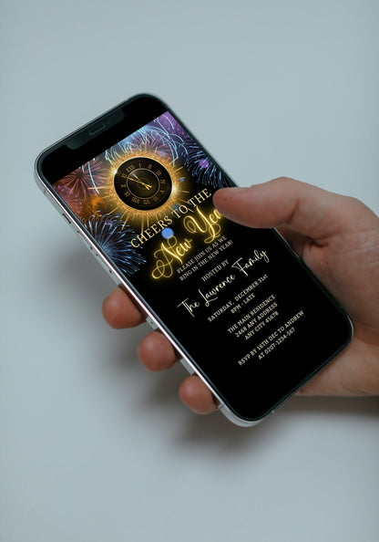 Hand holding a smartphone displaying a colourful fireworks clock for a New Year's Eve digital invitation, customizable via Canva for easy electronic sharing.