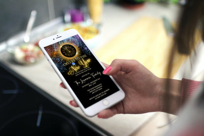 Hand holding a smartphone displaying a Colourful Fireworks Clock | New Years Eve Party Evite template for personalisation via Canva.