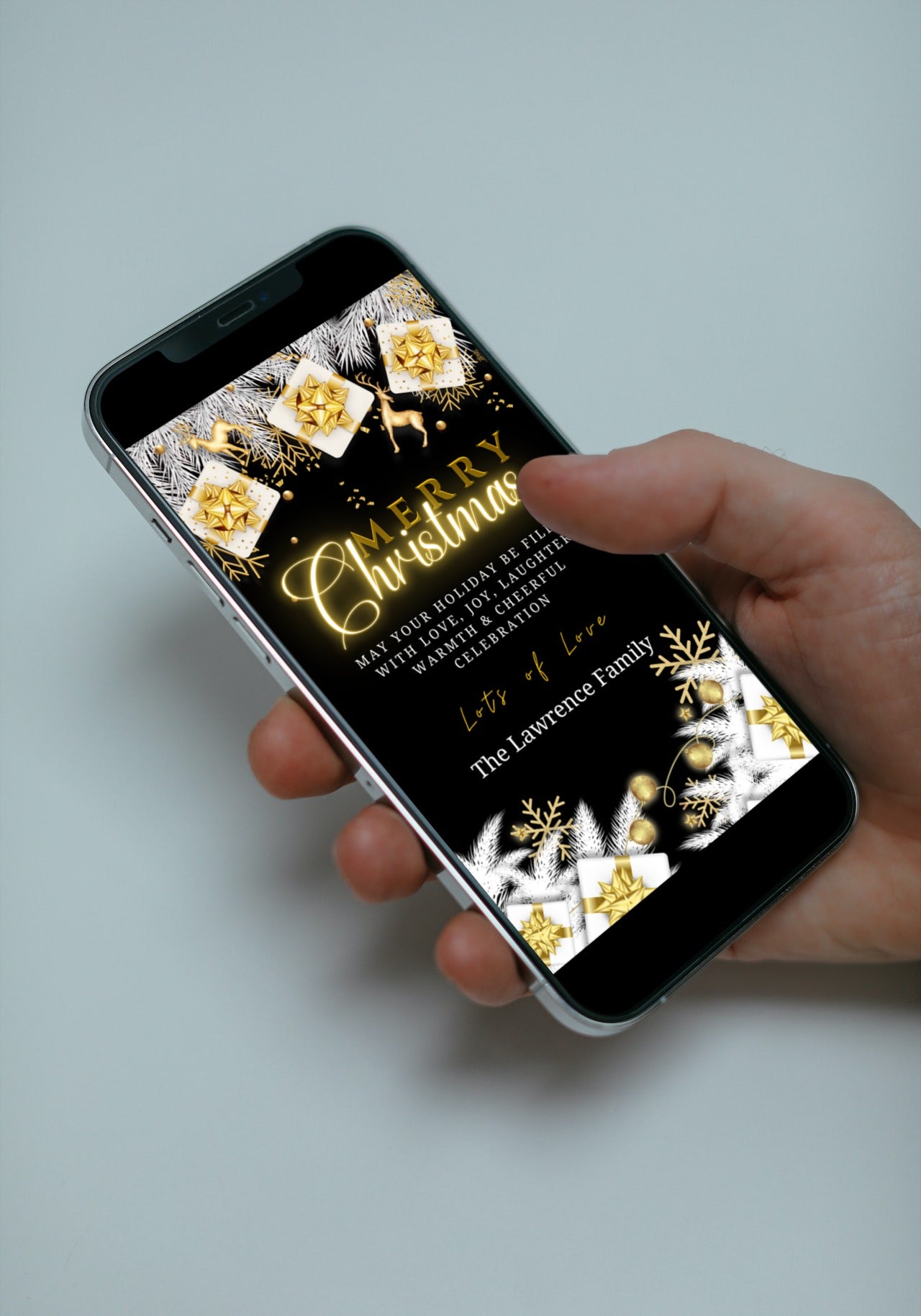 Hand holding a smartphone displaying an editable Neon White Gold Merry Christmas Ecard template for customization via Canva.