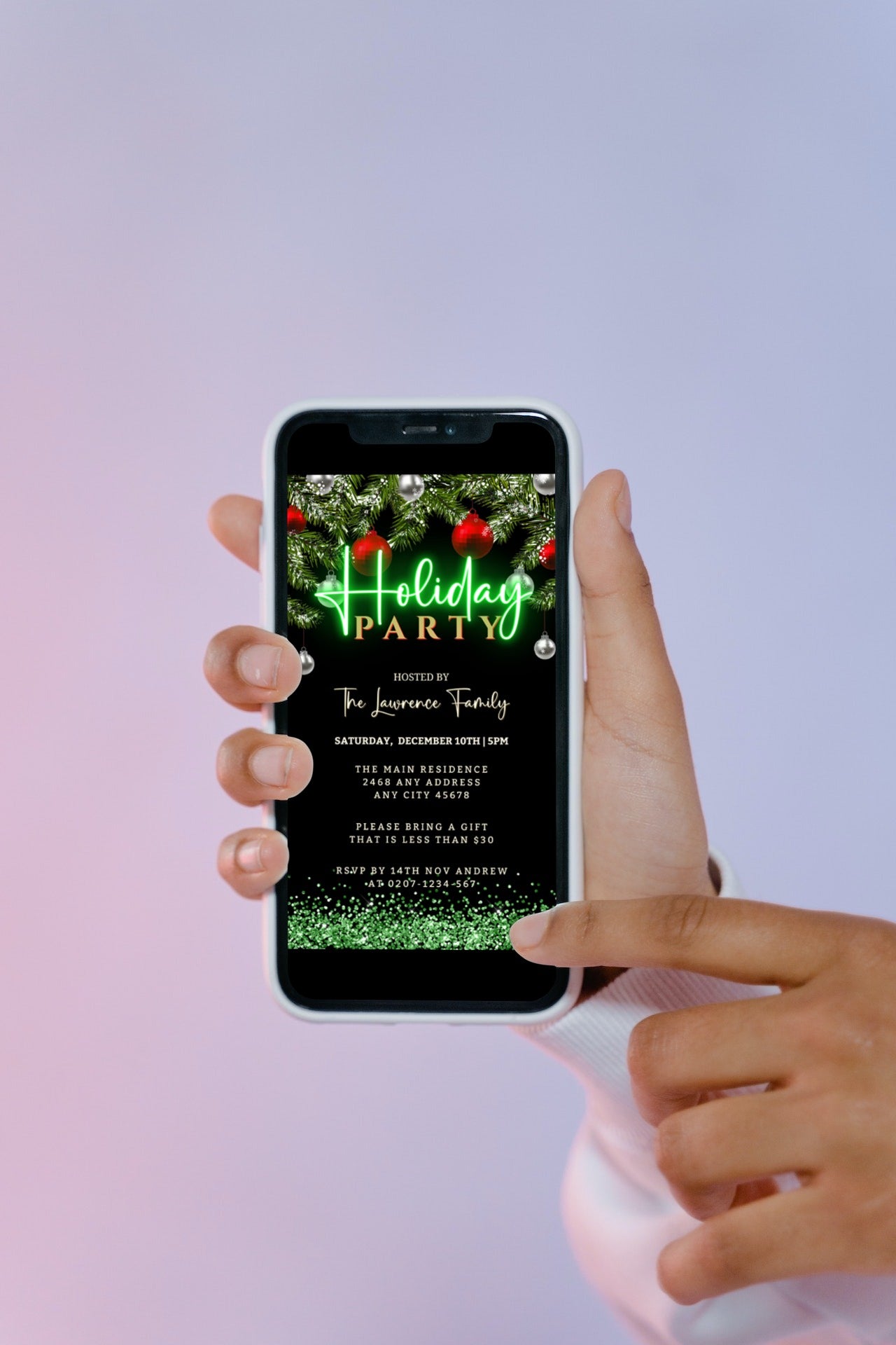 Hand holding a smartphone displaying a Green Neon Red Silver Ornament | Holiday Party Evite with editable details for customization using Canva.