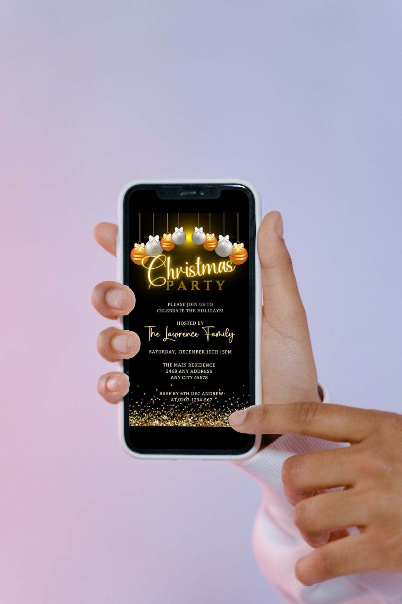 A hand holding a phone displaying a customizable Gold Silver Glitter Christmas Party invitation template from URCordiallyInvited.