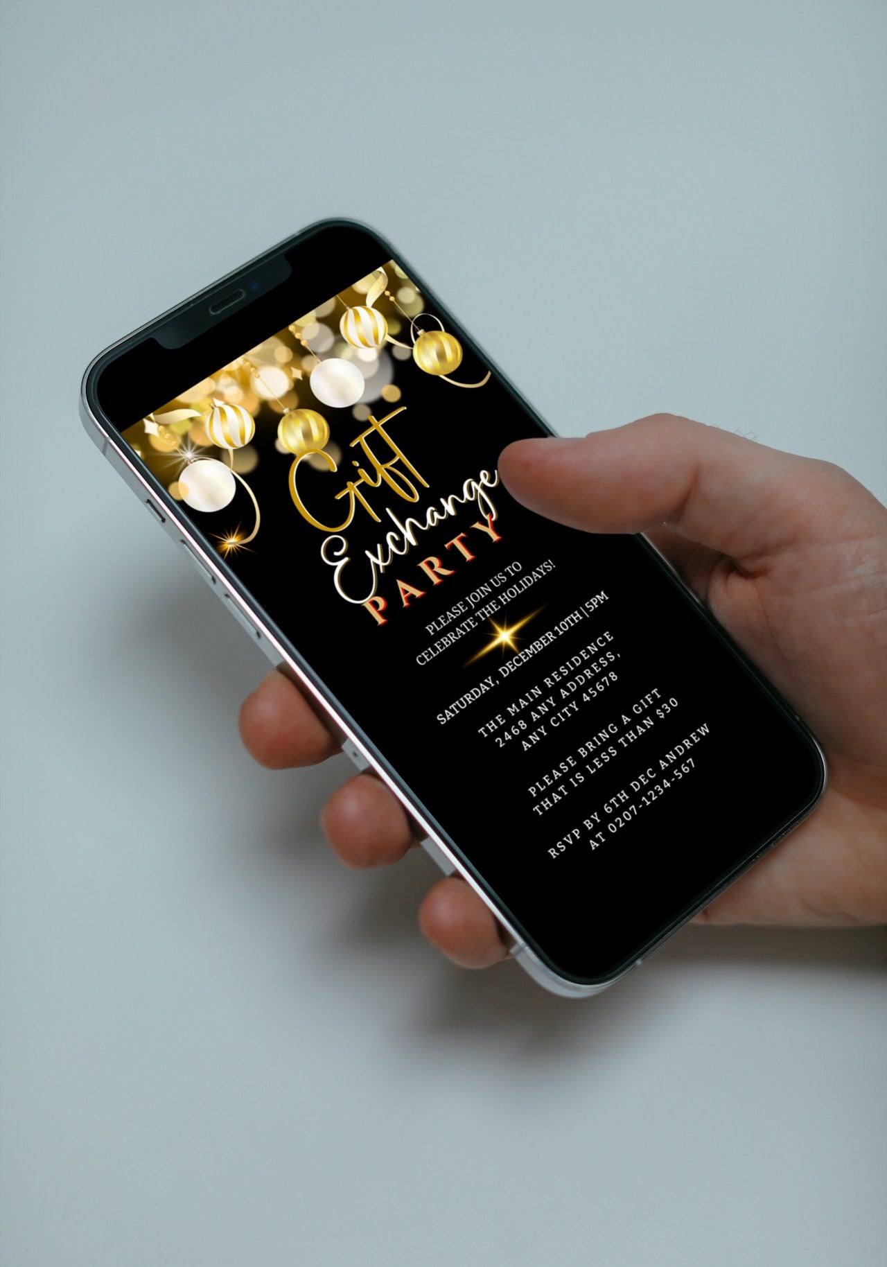 Hand holding a smartphone displaying an editable digital Black Gold White Ornaments Gift Exchange Christmas Party Evite.