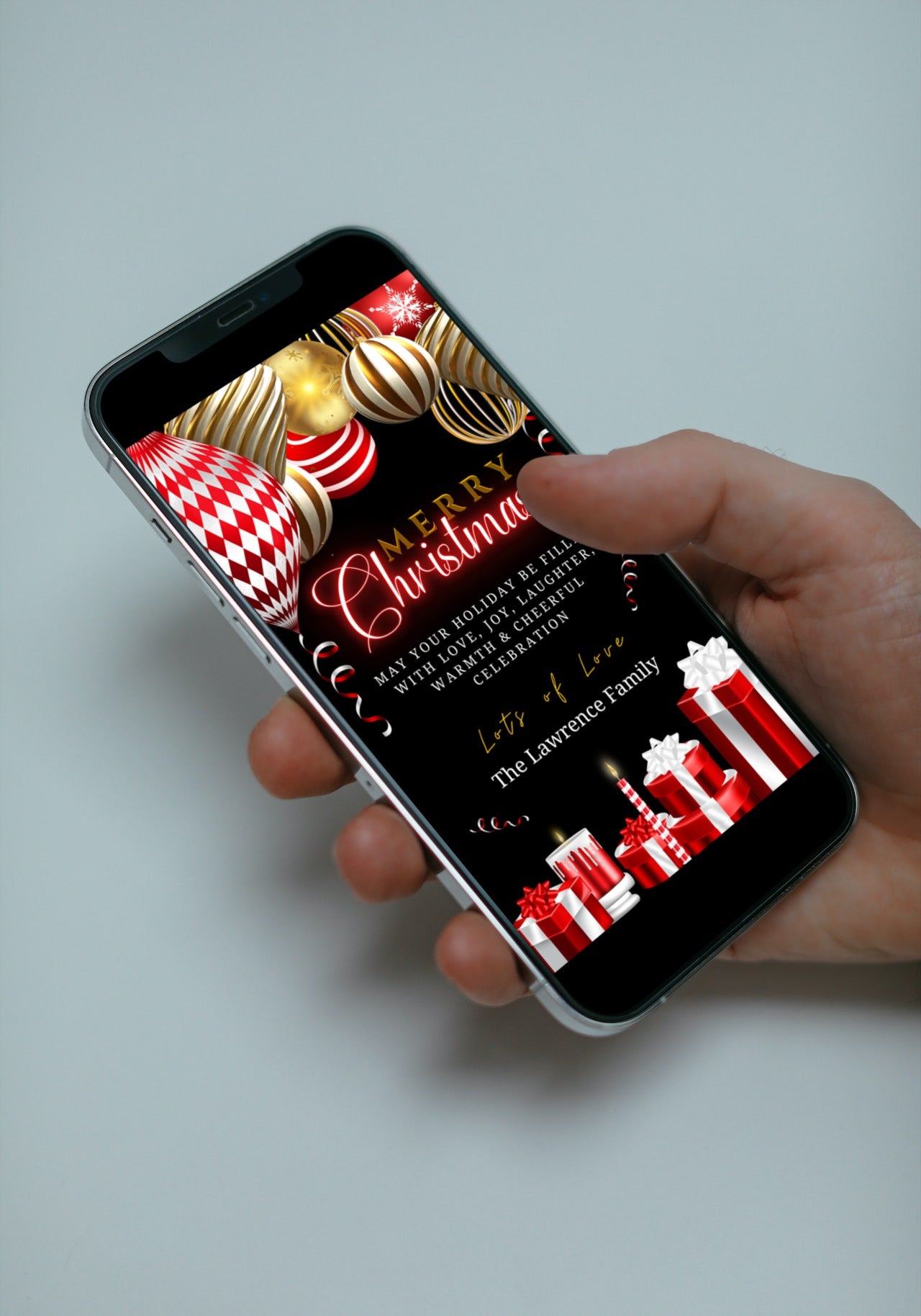 Hand holding a smartphone displaying a customizable Gold Red Neon Presents | Merry Christmas Greeting Ecard, perfect for digital invitations via text or email.