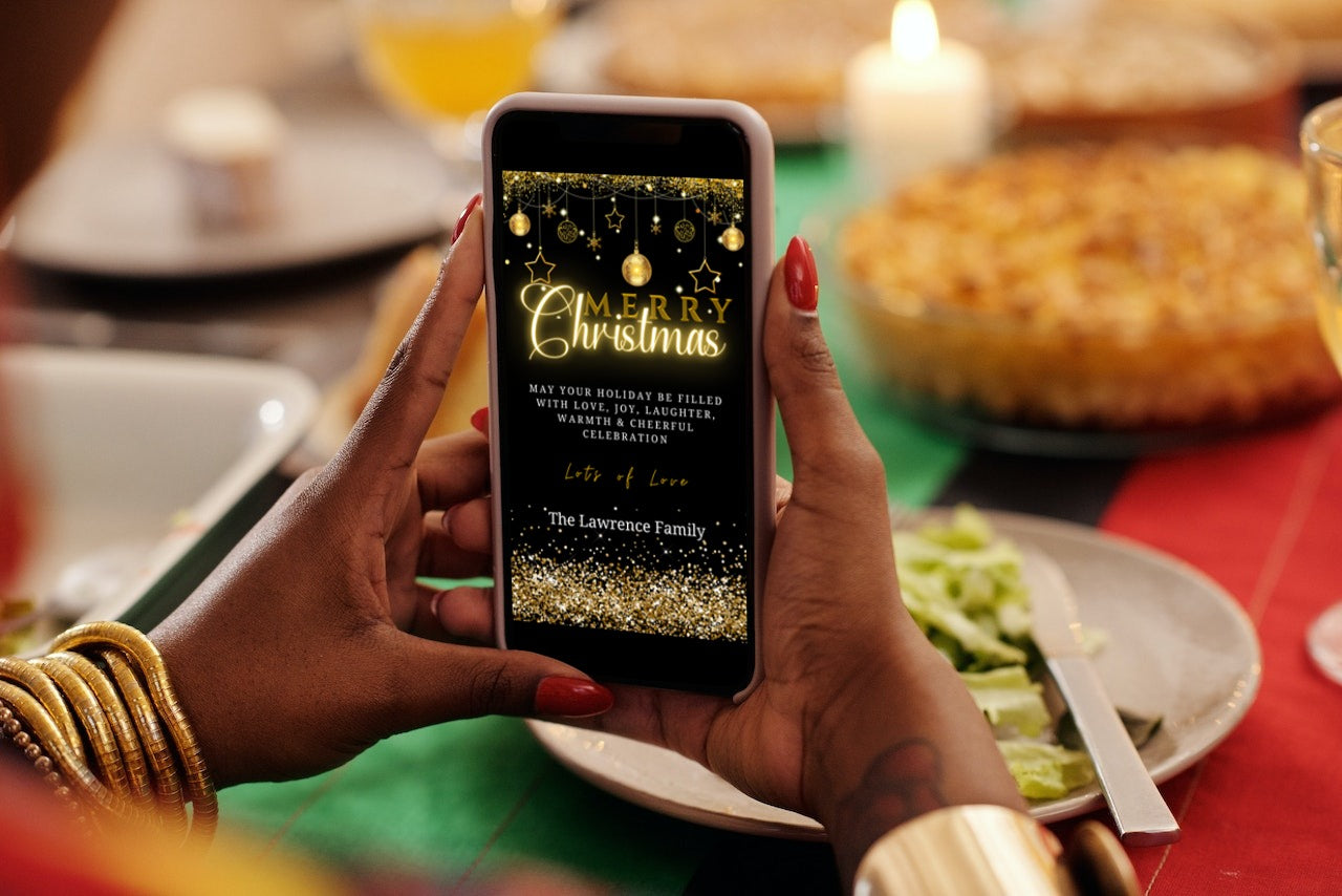 Person holding a smartphone displaying the Black Gold Ornaments Glitter Merry Christmas Greeting Ecard template from URCordiallyInvited.