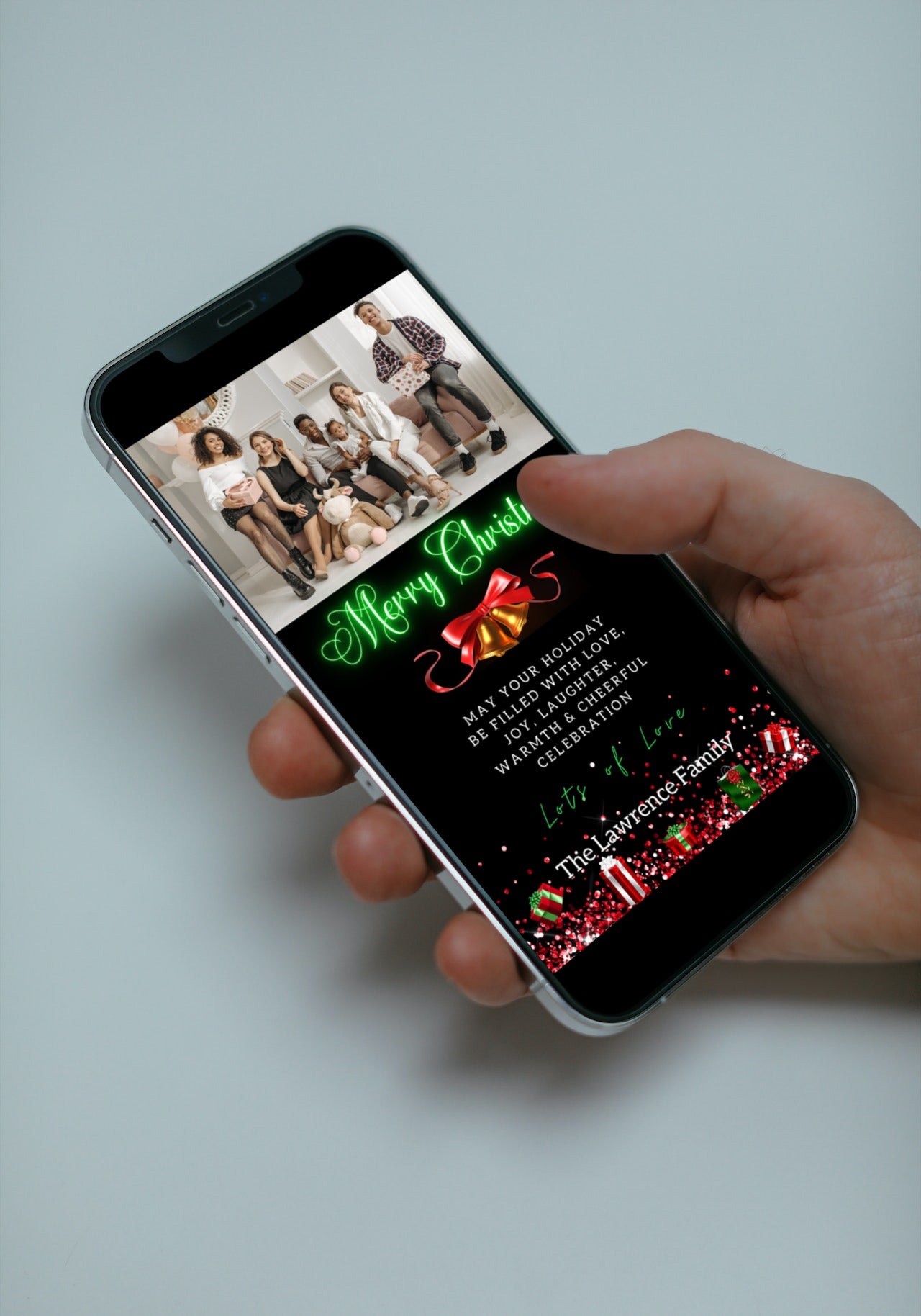 Hand holding a smartphone displaying the Neon Green Presents W/Photo Merry Christmas Greeting Ecard, editable via Canva for personalized digital invitations.