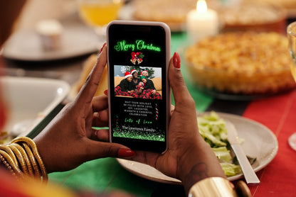 Person holding a smartphone displaying a Merry Christmas eCard with a family photo, part of the Black Neon Green customizable digital invitation collection.