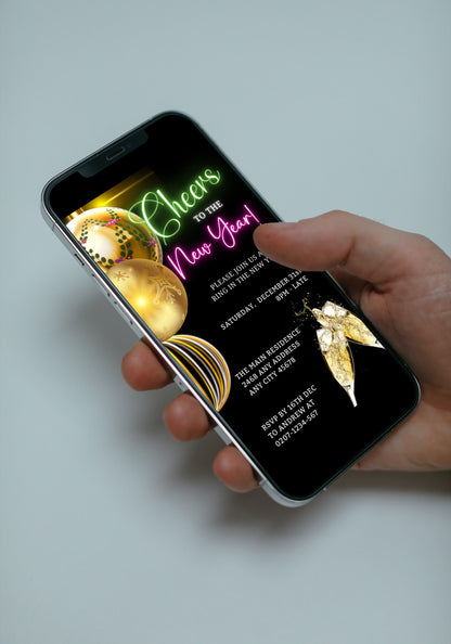 Hand holding a smartphone displaying the Neon Pink Green Ornaments Cheers New Year's Eve Party Evite, customizable via Canva for easy event personalization.