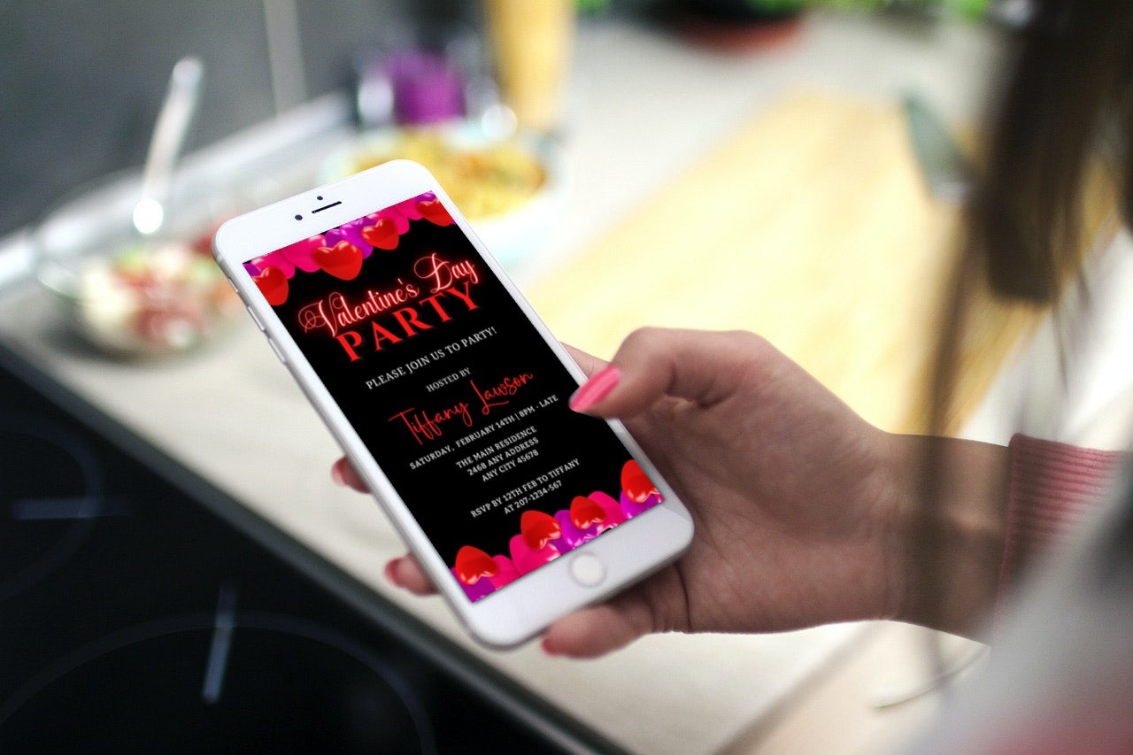 Hand holding a smartphone displaying the Black Pink Red Hearts | Valentines Party Evite for easy customization and sharing via digital platforms.